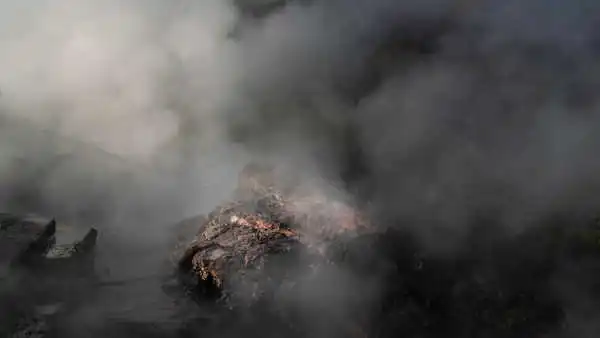 Steam from a hot spring over some red rock